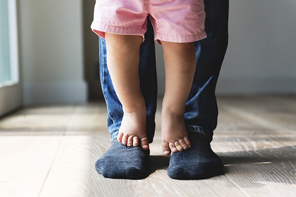 man with child standing on feet man with c